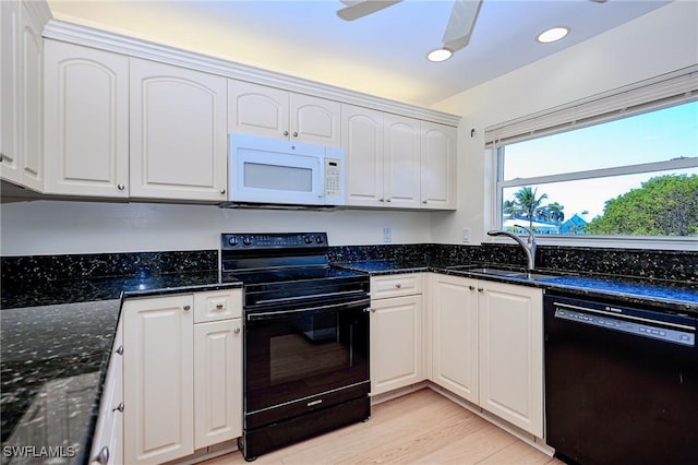 1100 8th Ave S Unit 309C, Naples, FL 34102 - kitchen featuring black appliances, a sink, white cabinets, recessed lighting, and dark stone counters