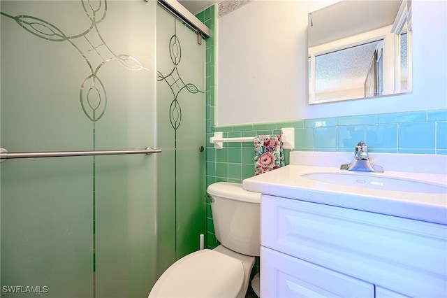 1100 8th Ave S Unit 309C, Naples, FL 34102 - full bath featuring tile walls, toilet, a shower stall, vanity, and wainscoting