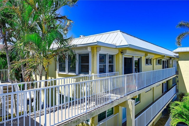1100 8th Ave S Unit 309C, Naples, FL 34102 - view of side of home with metal roof and stucco siding