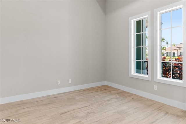 14302 Charthouse Cir, Naples, FL 34114 - spare room with wood finished floors and baseboards
