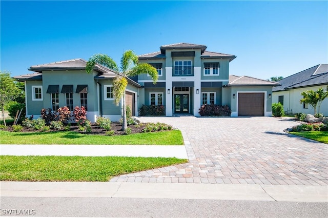 14302 Charthouse Cir, Naples, FL 34114 - view of front facade featuring a garage, decorative driveway, french doors, stucco siding, and a tiled roof