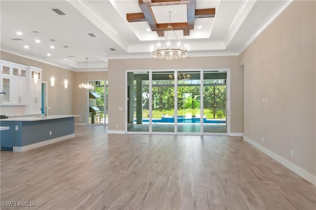 14302 Charthouse Cir, Naples, FL 34114 - unfurnished living room featuring a chandelier, healthy amount of natural light, ornamental molding, light wood-type flooring, and baseboards