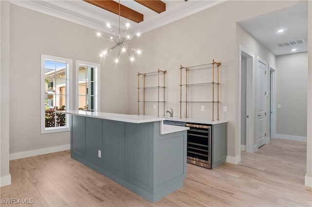 14302 Charthouse Cir, Naples, FL 34114 - spacious closet featuring beverage cooler, beam ceiling, a chandelier, light wood-style flooring, and bar with sink