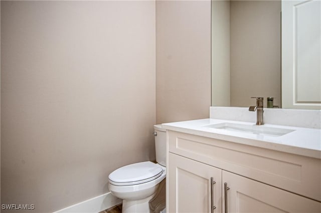 14302 Charthouse Cir, Naples, FL 34114 - bathroom with vanity, toilet, and baseboards