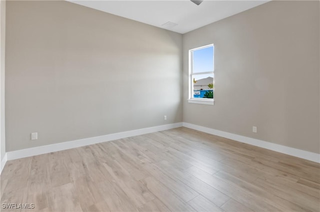 14302 Charthouse Cir, Naples, FL 34114 - empty room featuring light wood finished floors, ceiling fan, and baseboards