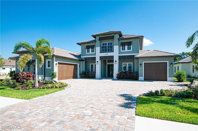 14302 Charthouse Cir, Naples, FL 34114 - view of front facade featuring an attached garage, stucco siding, and decorative driveway
