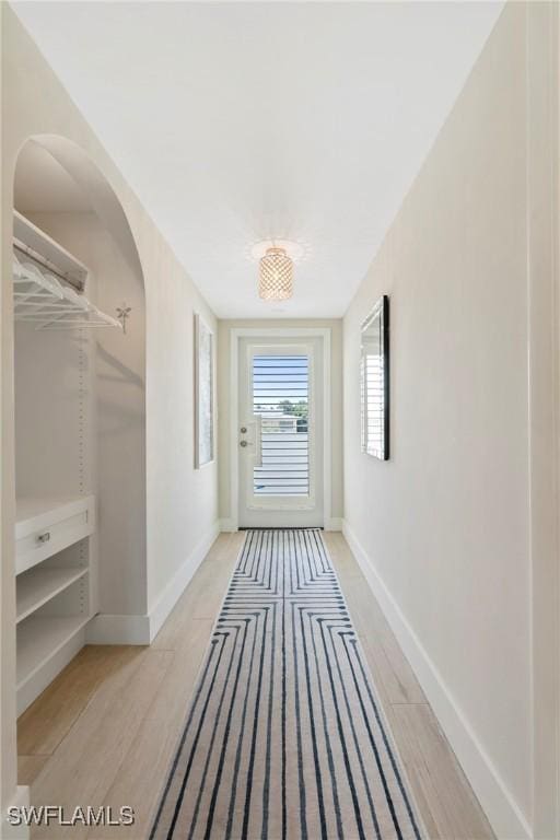 460 Broad Ave S Unit H460, Naples, FL 34102 - corridor featuring baseboards, light wood finished floors, and arched walkways