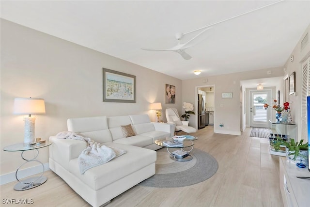 460 Broad Ave S Unit H460, Naples, FL 34102 - living area with ceiling fan, light wood-style floors, and baseboards