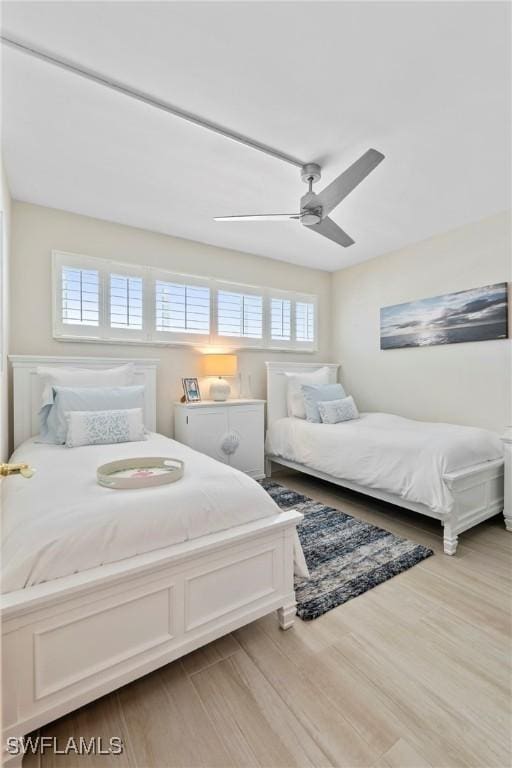 460 Broad Ave S Unit H460, Naples, FL 34102 - bedroom featuring multiple windows, wood finished floors, and ceiling fan