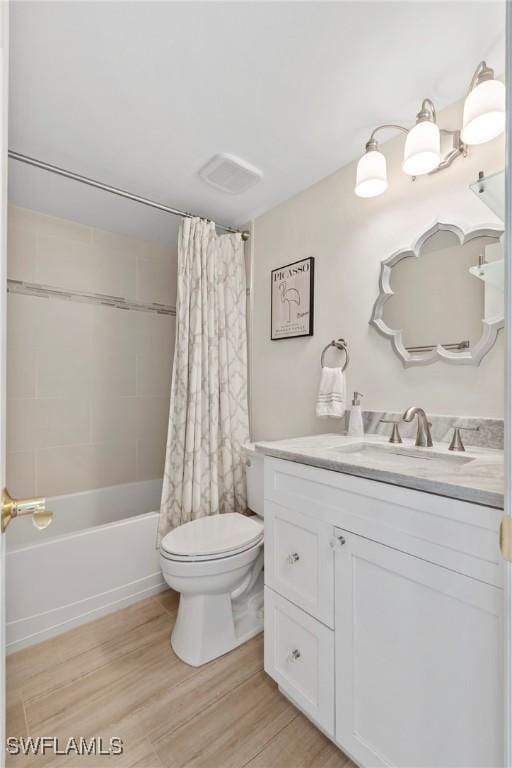 460 Broad Ave S Unit H460, Naples, FL 34102 - bathroom featuring vanity, toilet, shower / bathtub combination with curtain, and wood finished floors