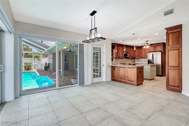 5012 SW 8th Pl, Cape Coral, FL 33914 - kitchen featuring stainless steel appliances, lofted ceiling, ceiling fan, tasteful backsplash, and light tile patterned floors