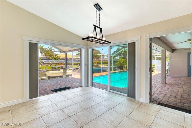 5012 SW 8th Pl, Cape Coral, FL 33914 - entryway featuring healthy amount of natural light, tile patterned floors, lofted ceiling, baseboards, and a sunroom