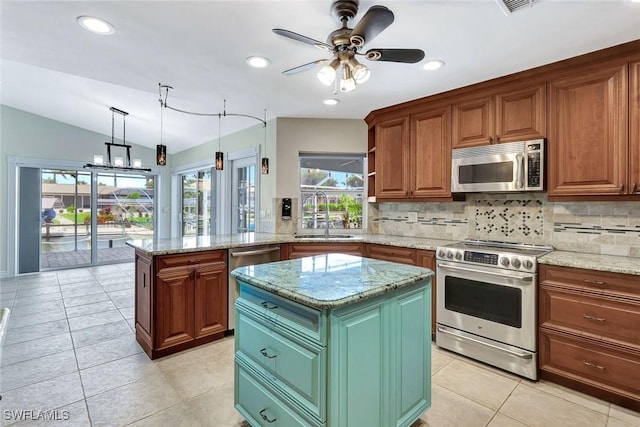 5012 SW 8th Pl, Cape Coral, FL 33914 - kitchen featuring appliances with stainless steel finishes, a sink, a center island, tasteful backsplash, and a ceiling fan