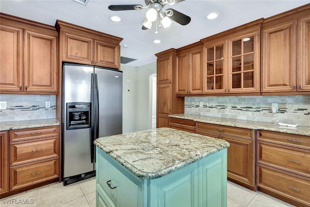 5012 SW 8th Pl, Cape Coral, FL 33914 - kitchen with stainless steel refrigerator with ice dispenser, light tile patterned flooring, brown cabinets, and recessed lighting