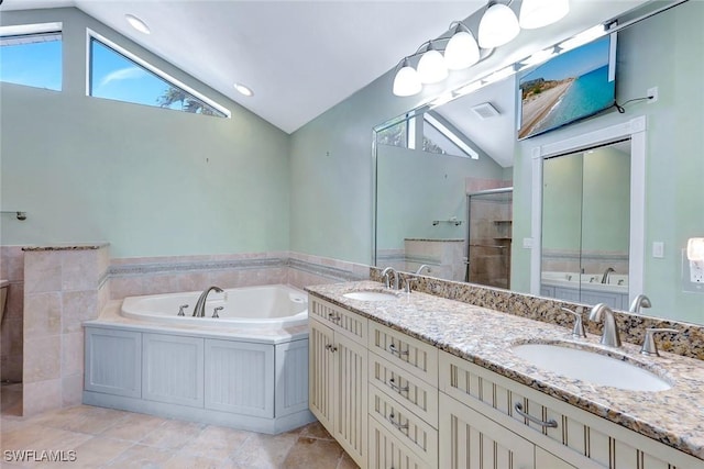 5012 SW 8th Pl, Cape Coral, FL 33914 - bathroom featuring lofted ceiling, a stall shower, a garden tub, double vanity, and plenty of natural light