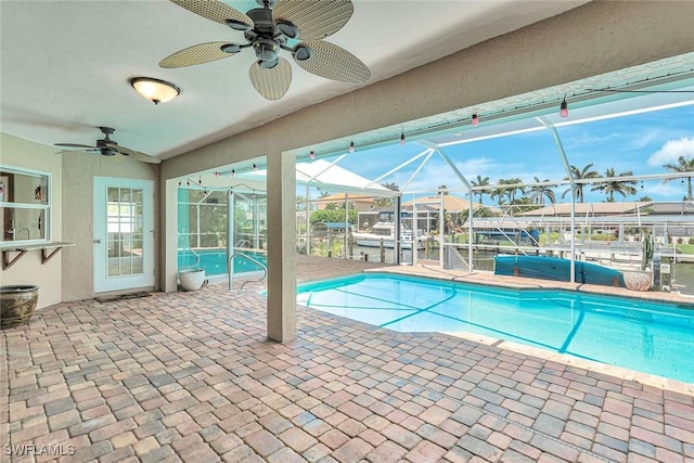 5012 SW 8th Pl, Cape Coral, FL 33914 - swimming pool featuring ceiling fan, a patio area, a lanai, a dock, and boat lift