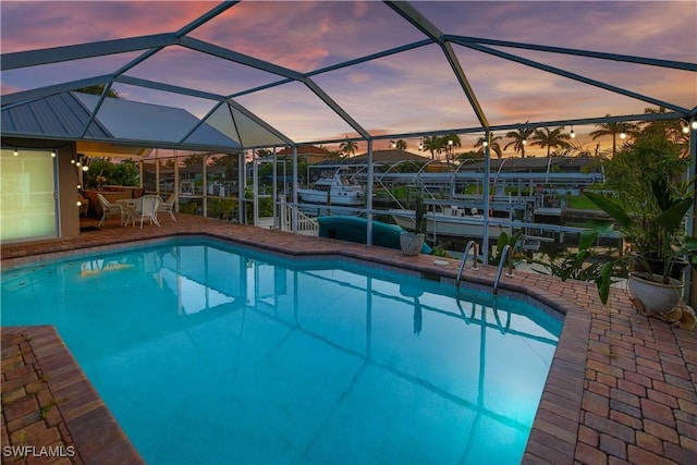 5012 SW 8th Pl, Cape Coral, FL 33914 - swimming pool with glass enclosure, a patio, boat lift, and a dock