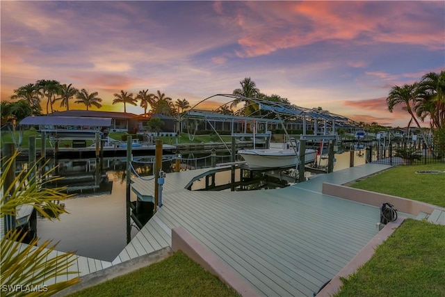 5012 SW 8th Pl, Cape Coral, FL 33914 - dock area featuring boat lift, a water view, and a lawn