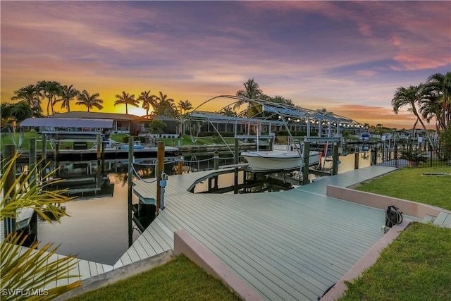 5012 SW 8th Pl, Cape Coral, FL 33914 - dock with boat lift, a water view, and a lawn