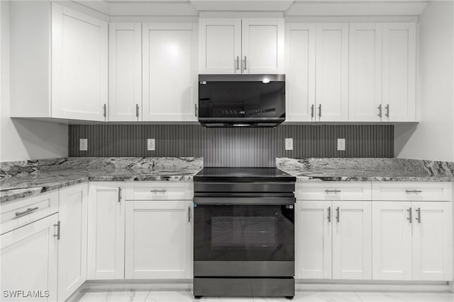 3613 39th St SW, Lehigh Acres, FL 33976 - kitchen with black electric range oven, light marble finish floors, white cabinets, and light stone counters