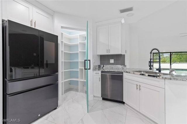 3613 39th St SW, Lehigh Acres, FL 33976 - kitchen with appliances with stainless steel finishes, a sink, light marble finish flooring, white cabinetry, and light stone countertops