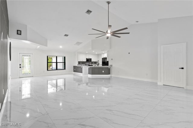 3613 39th St SW, Lehigh Acres, FL 33976 - unfurnished living room featuring baseboards, light marble finish flooring, a ceiling fan, high vaulted ceiling, and recessed lighting