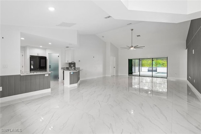 3613 39th St SW, Lehigh Acres, FL 33976 - unfurnished living room with high vaulted ceiling, a sink, light marble finish flooring, a ceiling fan, and baseboards