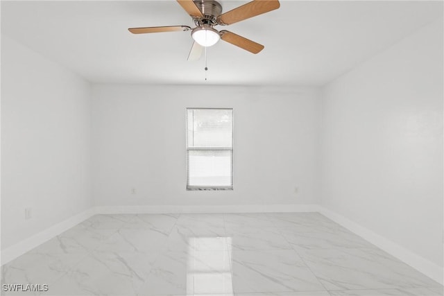 3613 39th St SW, Lehigh Acres, FL 33976 - unfurnished room with marble finish flooring, baseboards, and ceiling fan