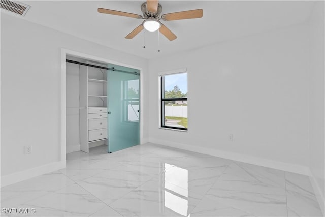 3613 39th St SW, Lehigh Acres, FL 33976 - unfurnished bedroom with baseboards, light marble finish floors, a ceiling fan, and a closet