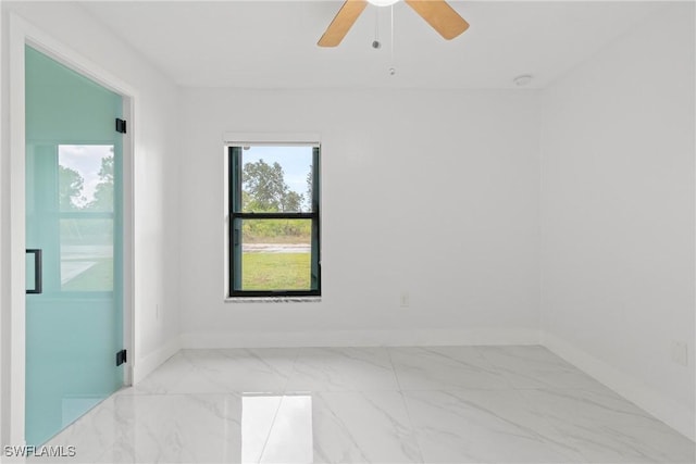 3613 39th St SW, Lehigh Acres, FL 33976 - spare room with marble look tile flooring, baseboards, and ceiling fan