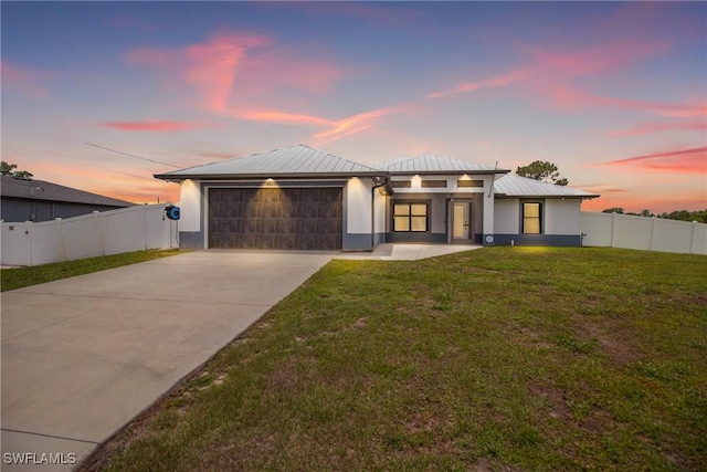 3613 39th St SW, Lehigh Acres, FL 33976 - view of front of home featuring an attached garage, concrete driveway, metal roof, stucco siding, and a standing seam roof