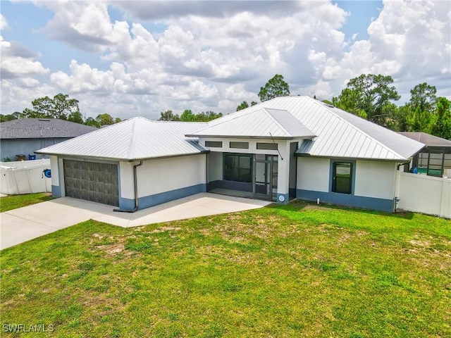 3613 39th St SW, Lehigh Acres, FL 33976 - view of front of home with stucco siding, a garage, concrete driveway, metal roof, and a sunroom