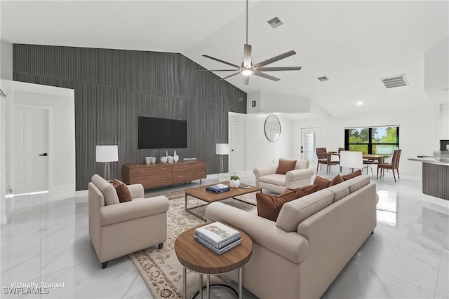 3613 39th St SW, Lehigh Acres, FL 33976 - living area featuring an accent wall, light marble finish floors, vaulted ceiling, a ceiling fan, and baseboards