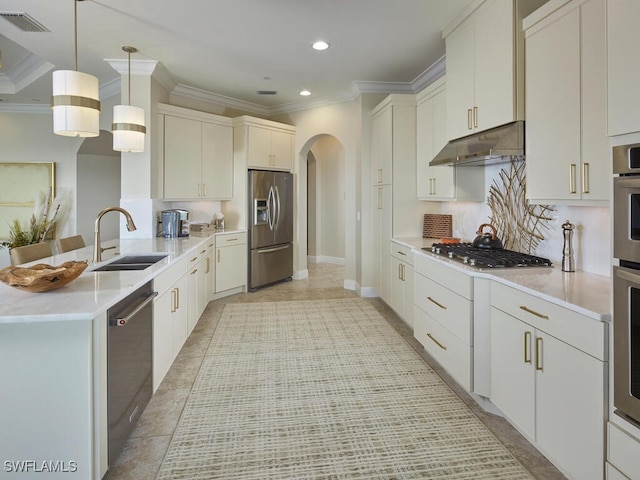 4701 Via Del Corso Ln Unit 401, Bonita Springs, FL 34134 - kitchen featuring appliances with stainless steel finishes, under cabinet range hood, arched walkways, crown molding, and a peninsula