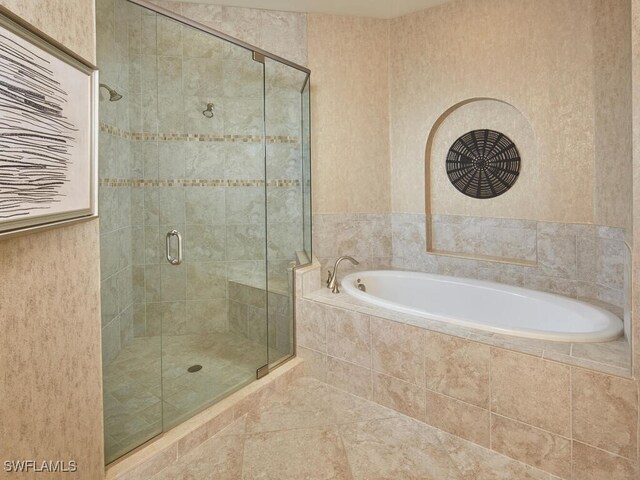 4701 Via Del Corso Ln Unit 401, Bonita Springs, FL 34134 - full bathroom featuring a stall shower, a bath, and tile patterned flooring
