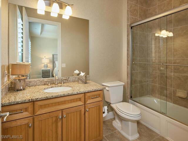 4701 Via Del Corso Ln Unit 401, Bonita Springs, FL 34134 - bathroom featuring vanity, tile patterned floors, and shower / bath combination with glass door