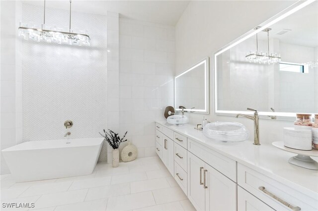160 SW 52nd Ter, Cape Coral, FL 33914 - full bathroom featuring double vanity, a freestanding bath, tile patterned floors, and a chandelier