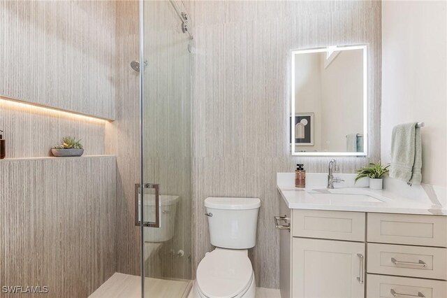 160 SW 52nd Ter, Cape Coral, FL 33914 - bathroom with toilet, vanity, and a shower stall