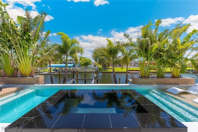 160 SW 52nd Ter, Cape Coral, FL 33914 - view of swimming pool with a dock, a water view, a pool with connected hot tub, and boat lift