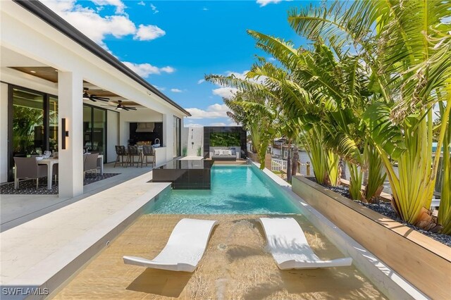 160 SW 52nd Ter, Cape Coral, FL 33914 - outdoor pool featuring a ceiling fan, a fenced backyard, a patio area, and an outdoor living space