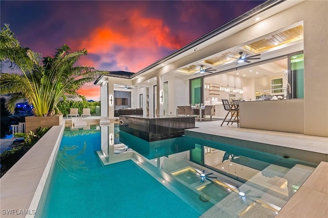 160 SW 52nd Ter, Cape Coral, FL 33914 - pool at dusk with a ceiling fan, a patio area, and an outdoor pool