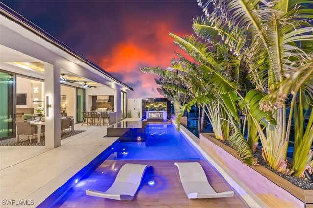 160 SW 52nd Ter, Cape Coral, FL 33914 - swimming pool featuring ceiling fan, exterior bar, a patio, and a jacuzzi