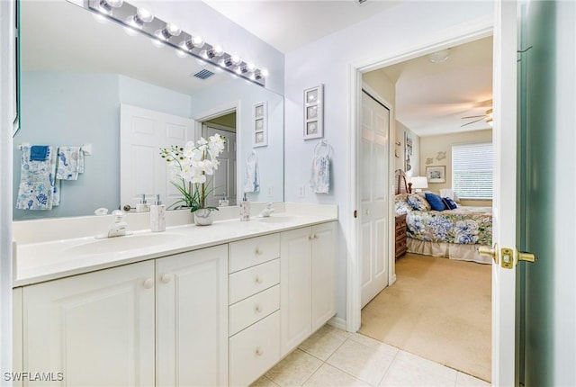 4011 Palm Tree Blvd Unit 208, Cape Coral, FL 33904 - bathroom featuring double vanity, a ceiling fan, tile patterned flooring, and ensuite bathroom