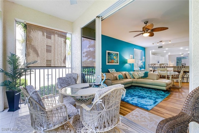 4011 Palm Tree Blvd Unit 208, Cape Coral, FL 33904 - living room featuring ceiling fan, wood finished floors, and track lighting