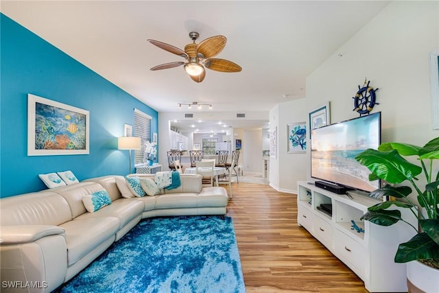 4011 Palm Tree Blvd Unit 208, Cape Coral, FL 33904 - living room featuring track lighting, light wood-style flooring, ceiling fan, and baseboards