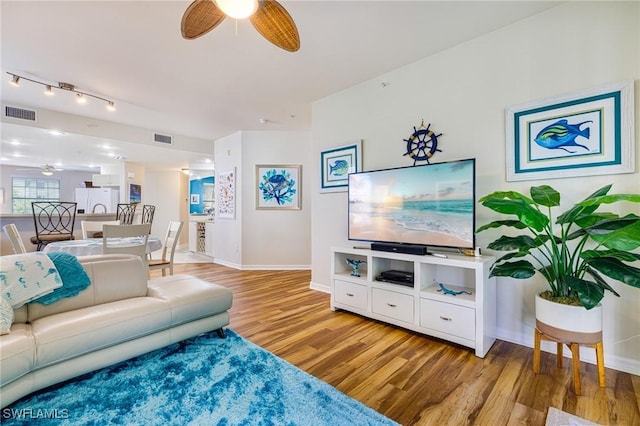 4011 Palm Tree Blvd Unit 208, Cape Coral, FL 33904 - living area with a ceiling fan, wood finished floors, baseboards, and track lighting