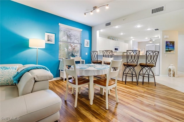 4011 Palm Tree Blvd Unit 208, Cape Coral, FL 33904 - dining room featuring light wood-type flooring, baseboards, and a ceiling fan