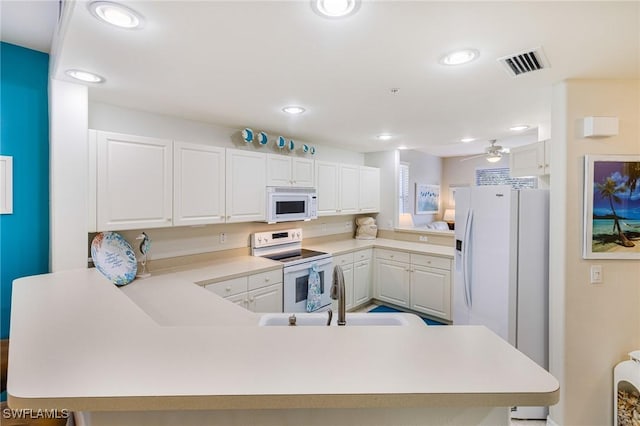 4011 Palm Tree Blvd Unit 208, Cape Coral, FL 33904 - kitchen with white appliances, a peninsula, a sink, light countertops, and recessed lighting