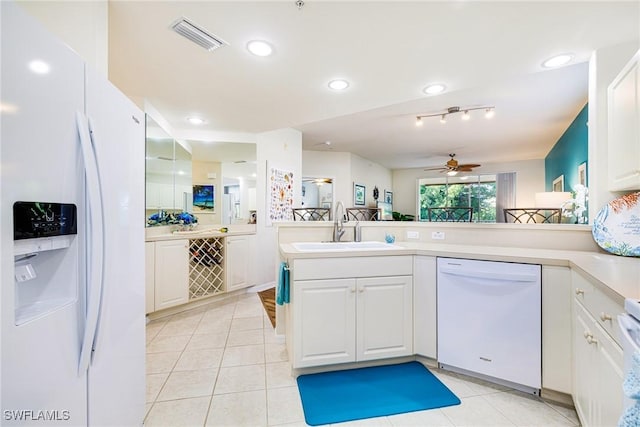 4011 Palm Tree Blvd Unit 208, Cape Coral, FL 33904 - kitchen with white appliances, a sink, a ceiling fan, white cabinetry, and light tile patterned flooring