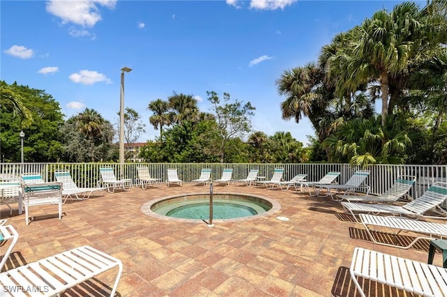 4011 Palm Tree Blvd Unit 208, Cape Coral, FL 33904 - view of swimming pool featuring a patio area, a hot tub, and view of wooded area